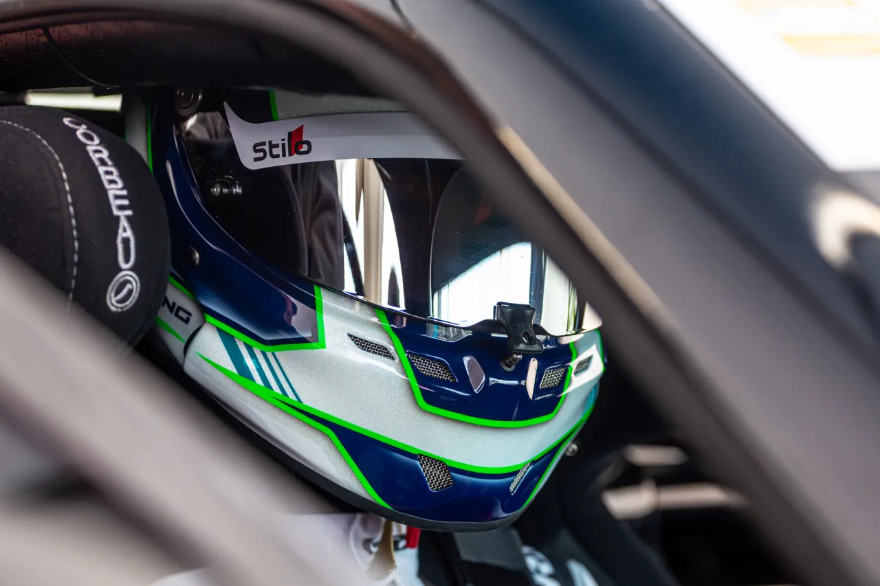 Close-up of Noah Young's race helmet in the cockpit of his Ginetta