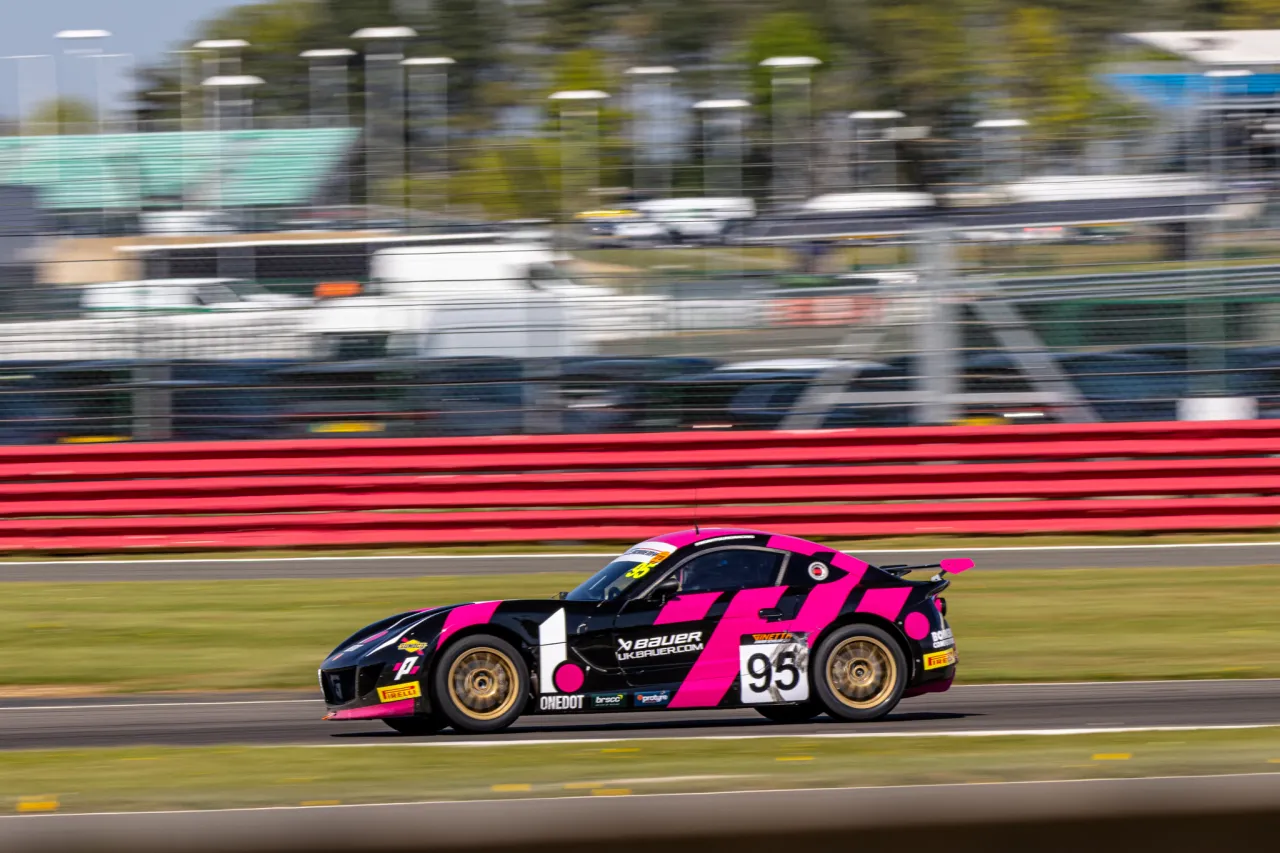 Noah Young's number 95 Ginetta at speed along the start straight at Silverstone