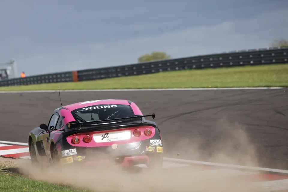 Noah Young's number 95 Ginetta kicking up dust running wide at a corner