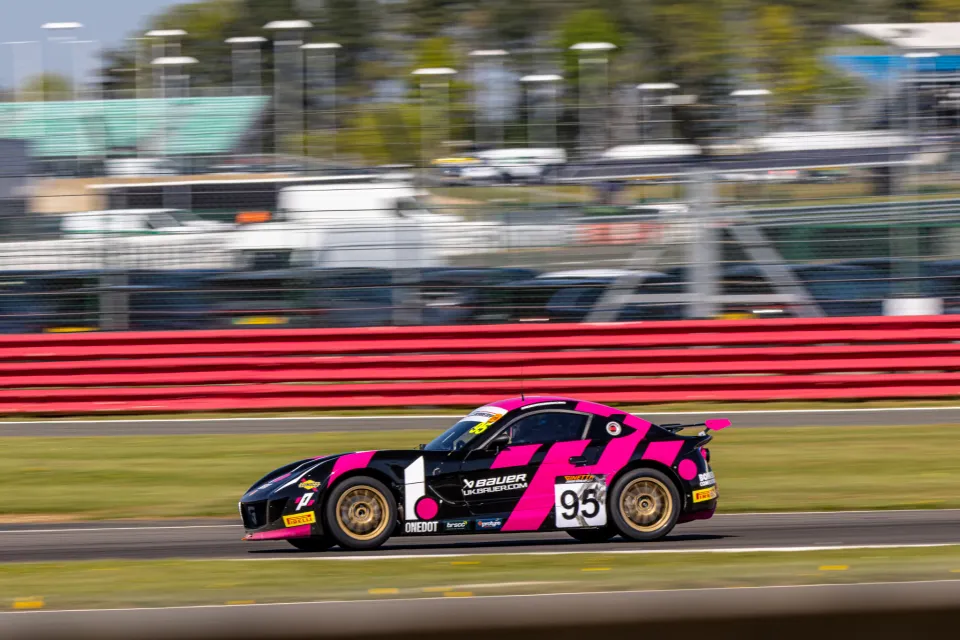 Noah Young's number 95 Ginetta at speed along the start straight at Silverstone