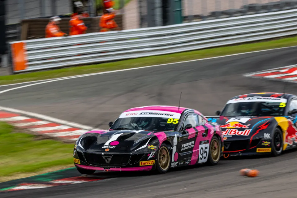 Noah Young racing wheel-to-wheel with a rival Ginetta Junior driver
